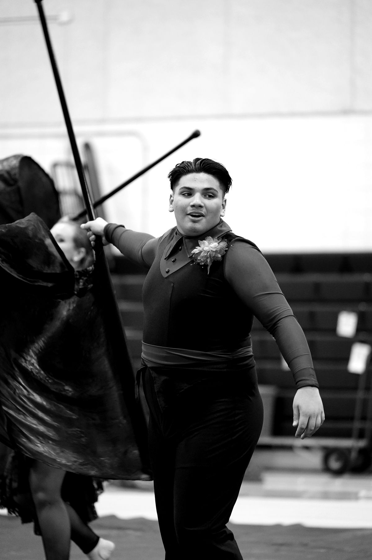 Morgan mid-performance, carrying a large black silk flag.